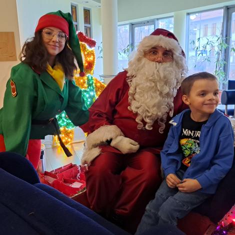 Elf oraz  Mikołaj w saniach z pacjentem. 